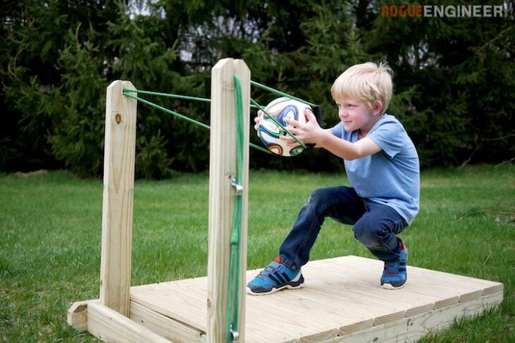 kid using a backyard slingshot