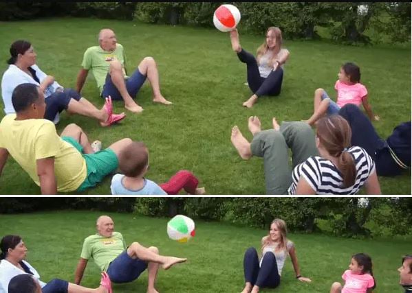 a family hitting a beach ball with their feet