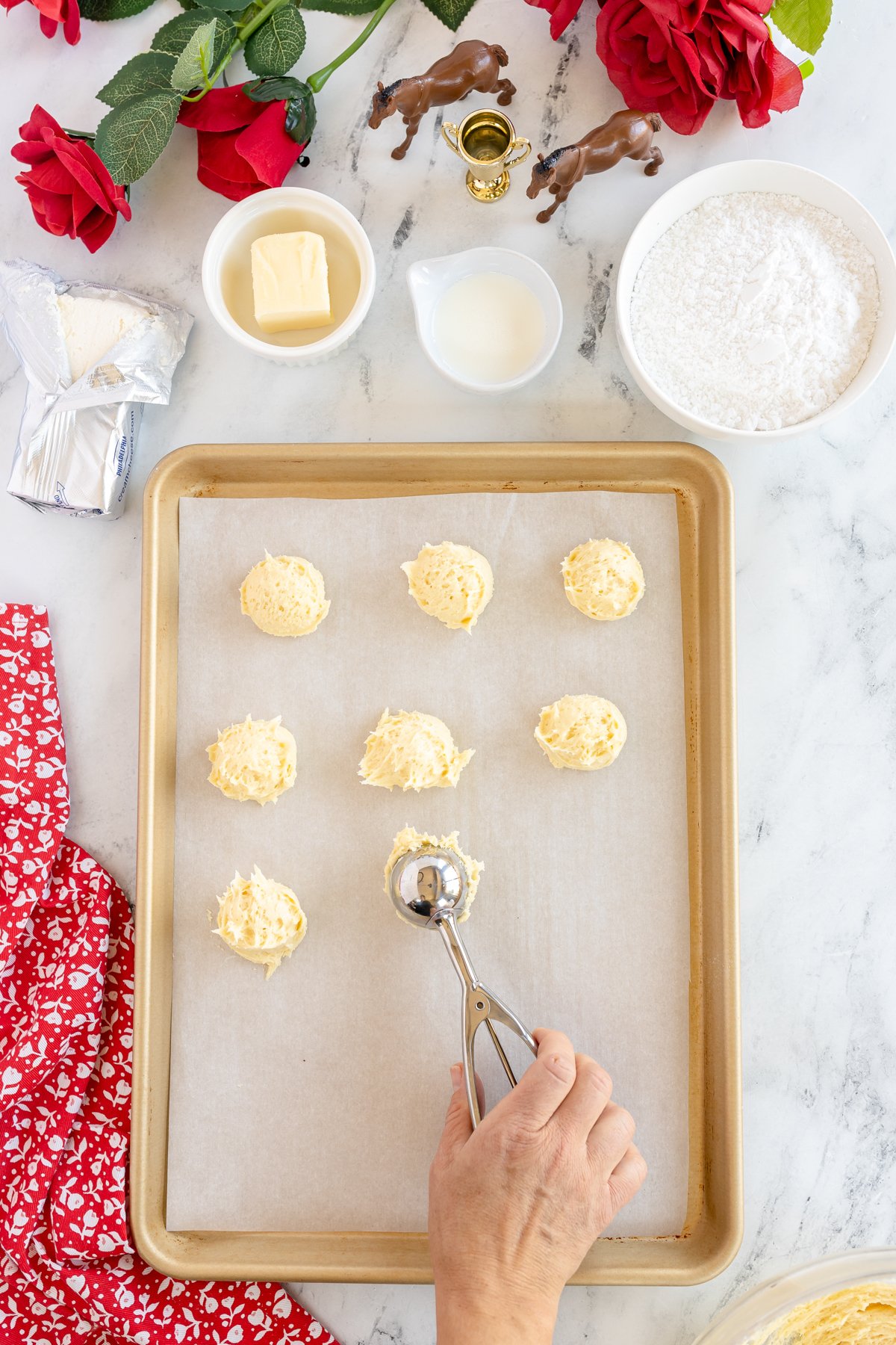 placing scoops of cookie dough onto a baking sheet