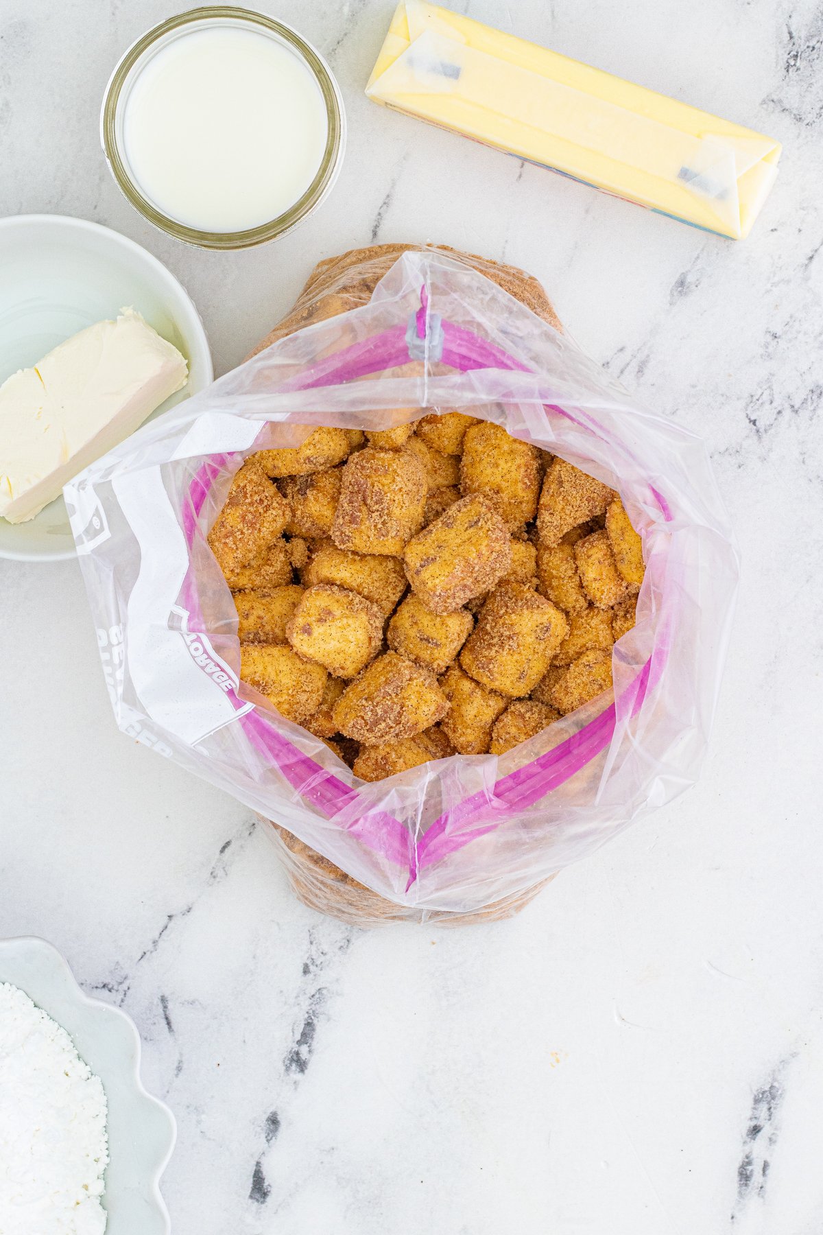 plastic bag with cinnamon sugar coated cinnamon roll bites