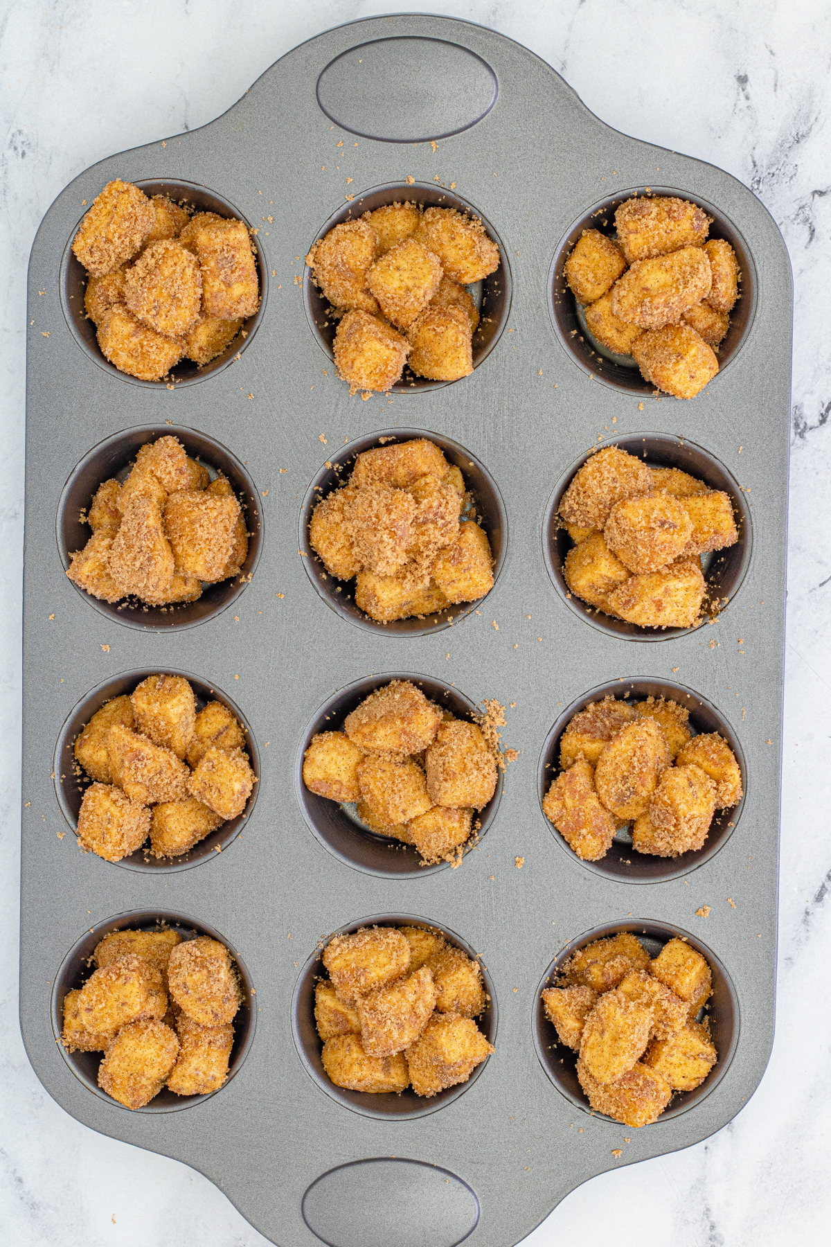muffin tin with unbaked monkey bread muffins