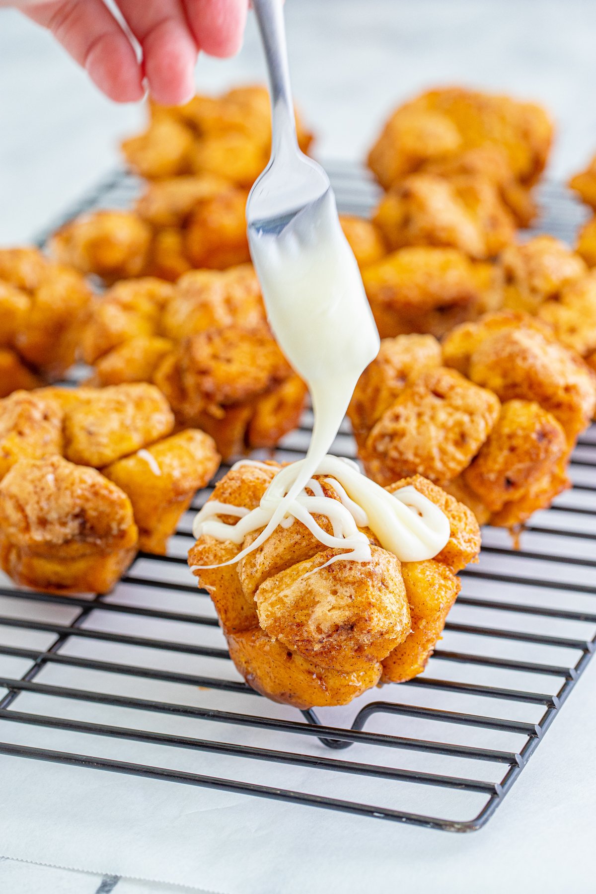 drizzling icing on monkey bread muffins