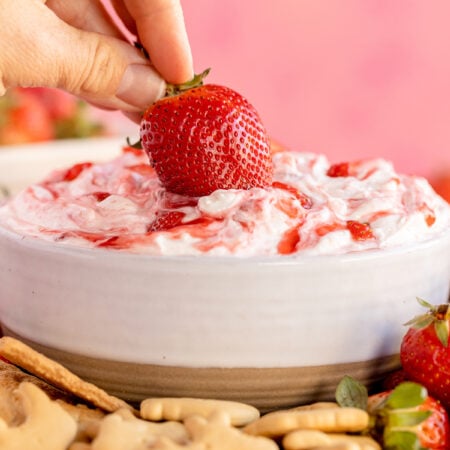 dipping a strawberry into strawberry dip