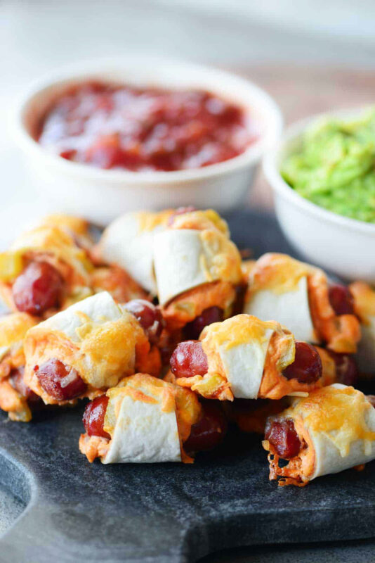 cutting board with Mexican pigs in a blanket