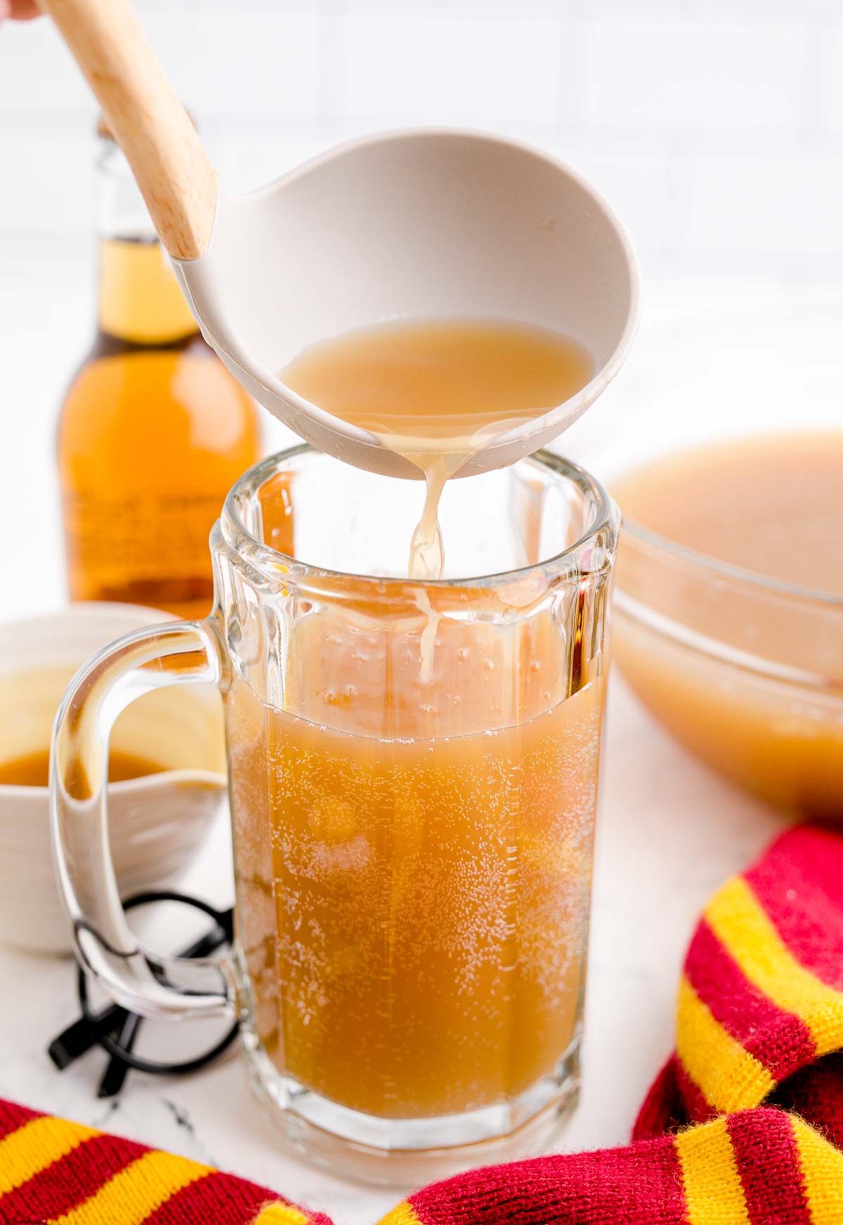 ladeling butterbeer into a glass