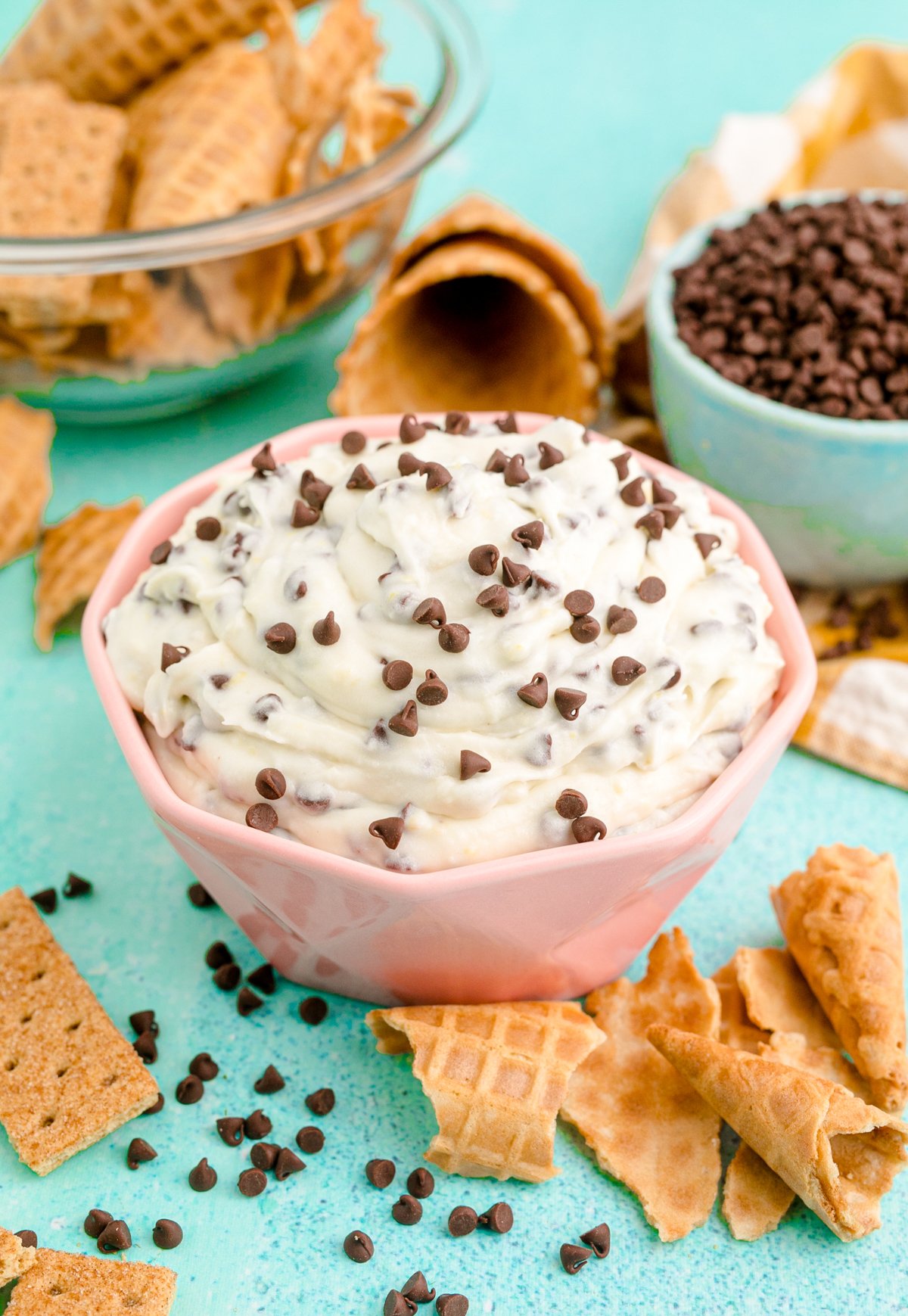 pink bowl with cannoli dip and waffle cones