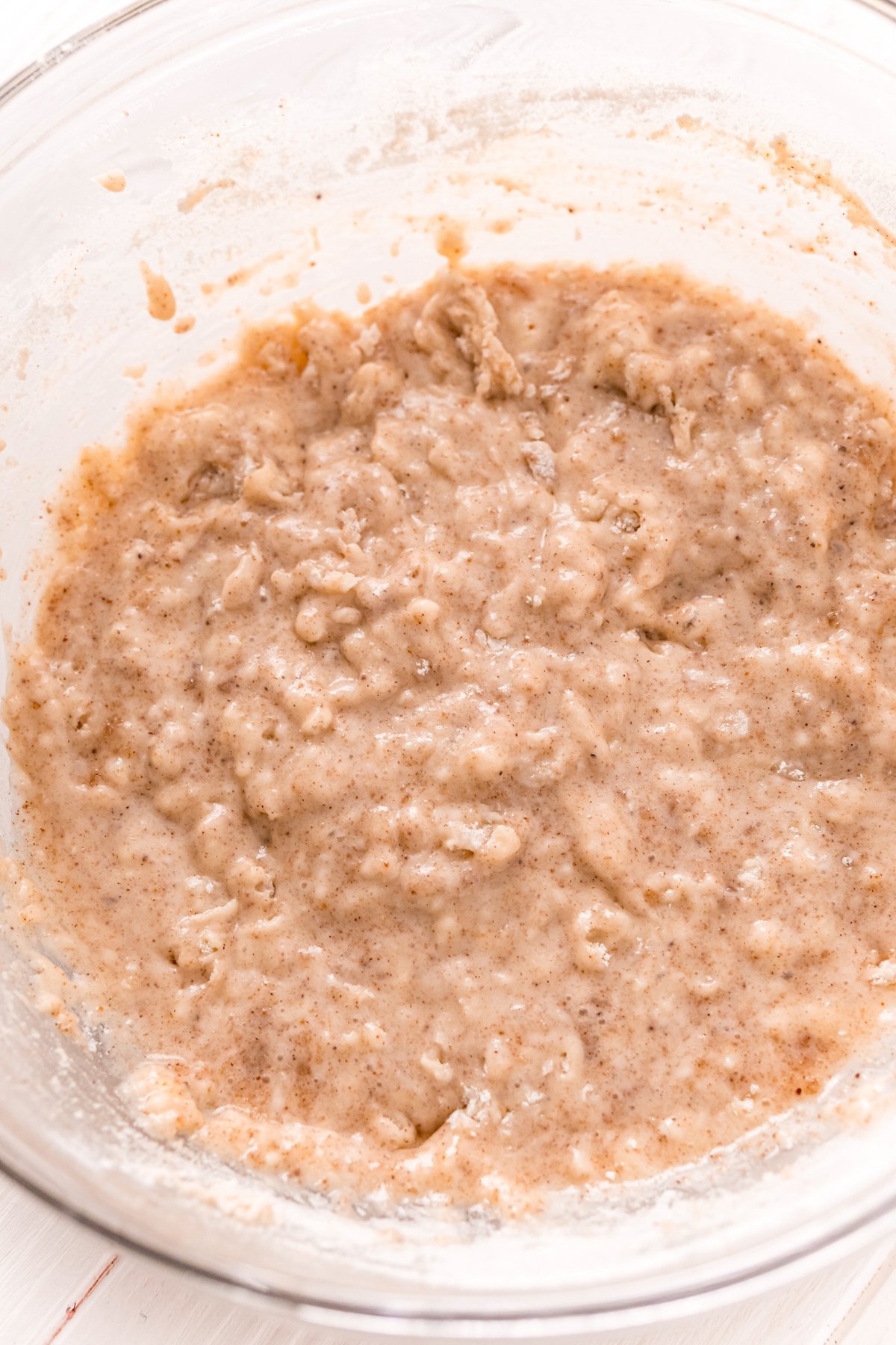 batter for cinnamon sugar donut muffins in a glass bowl