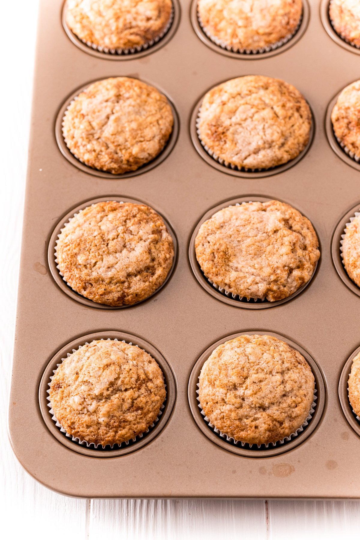 cinnamon sugar muffins in a muffin tin