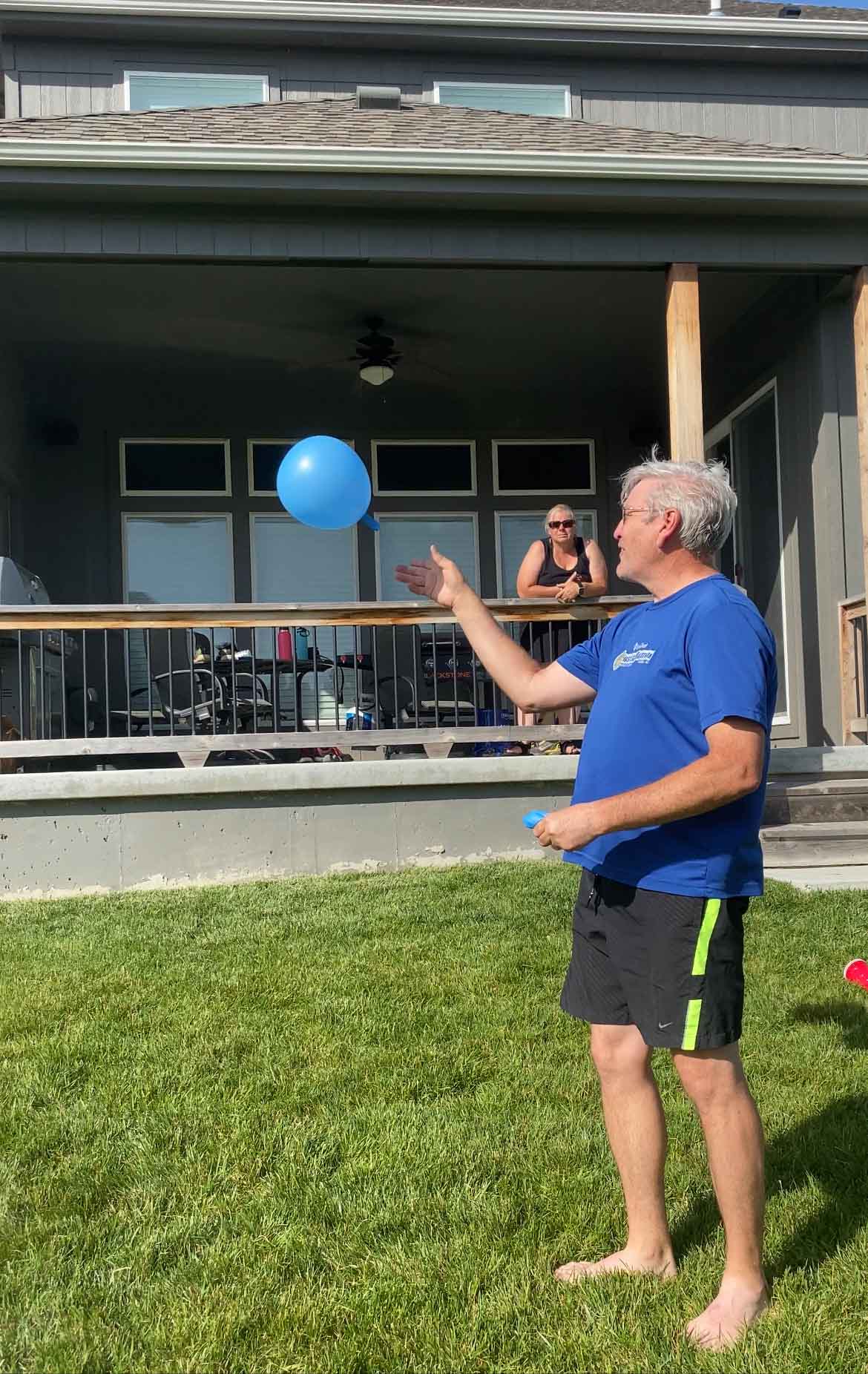 man letting a balloon go