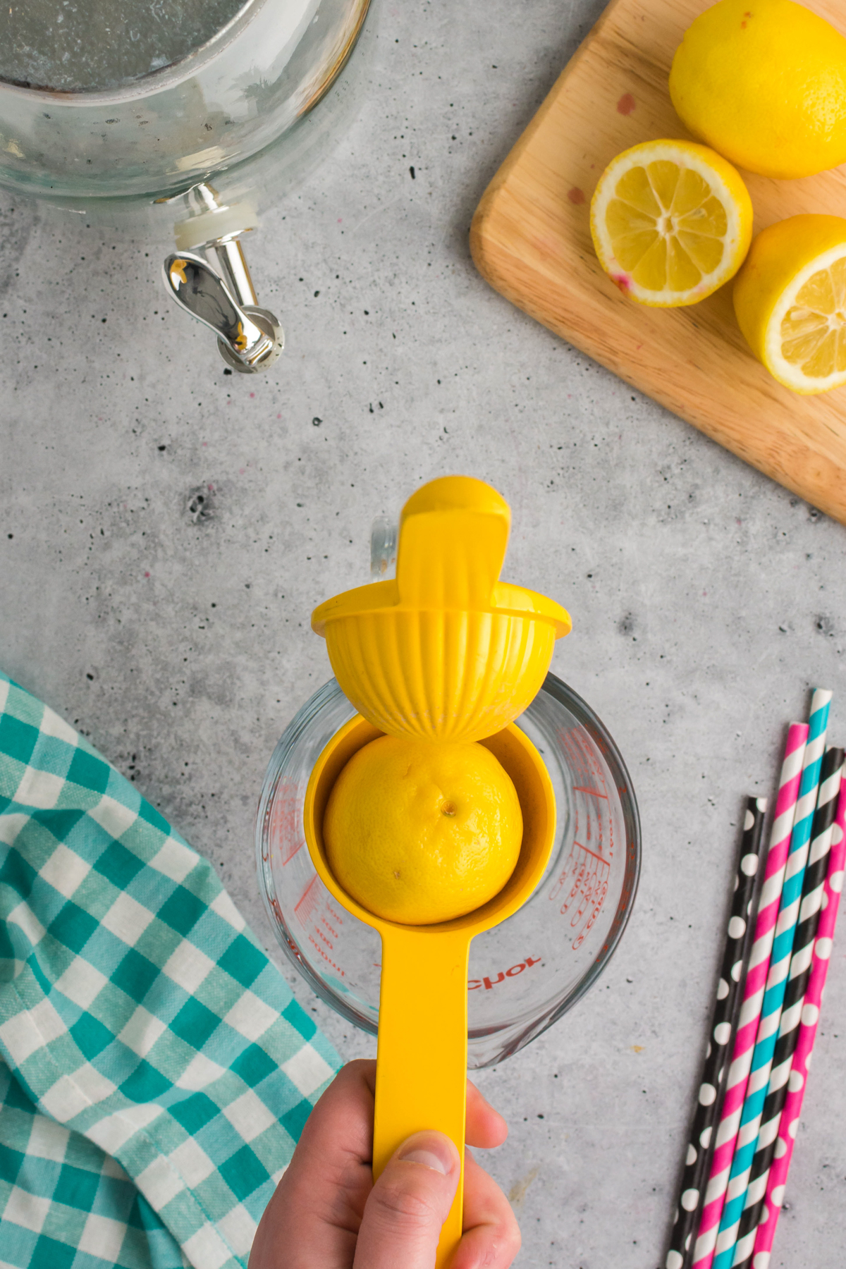 lemon juicer over a glass measuring cup