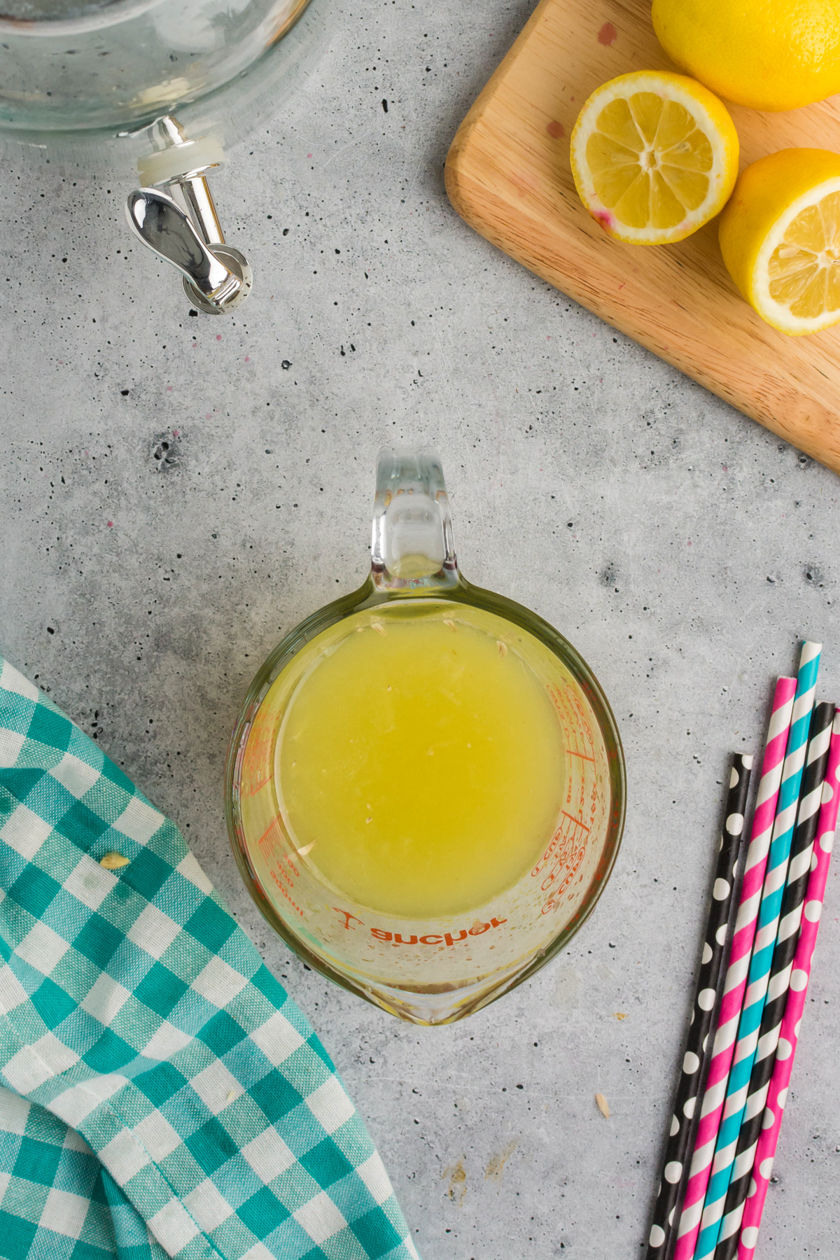 measuring glass with lemon juice