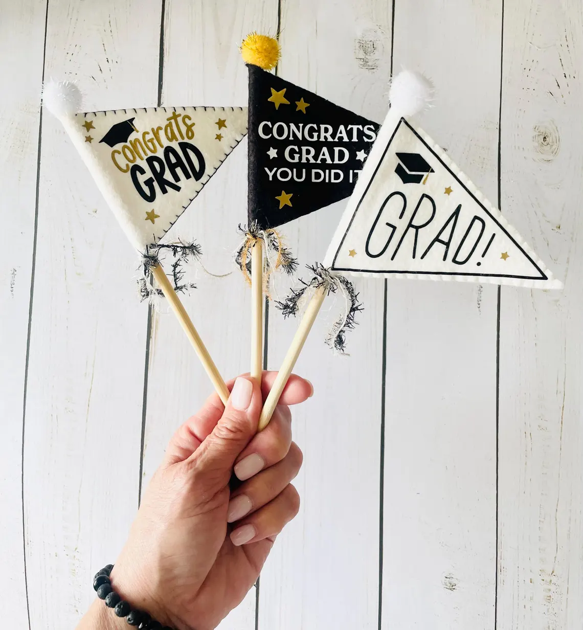 hand holding graduation pennants