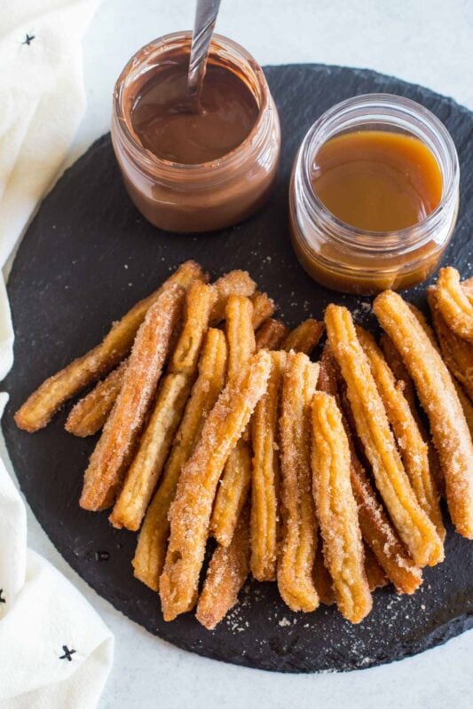 churros on a plate with dipping sauces