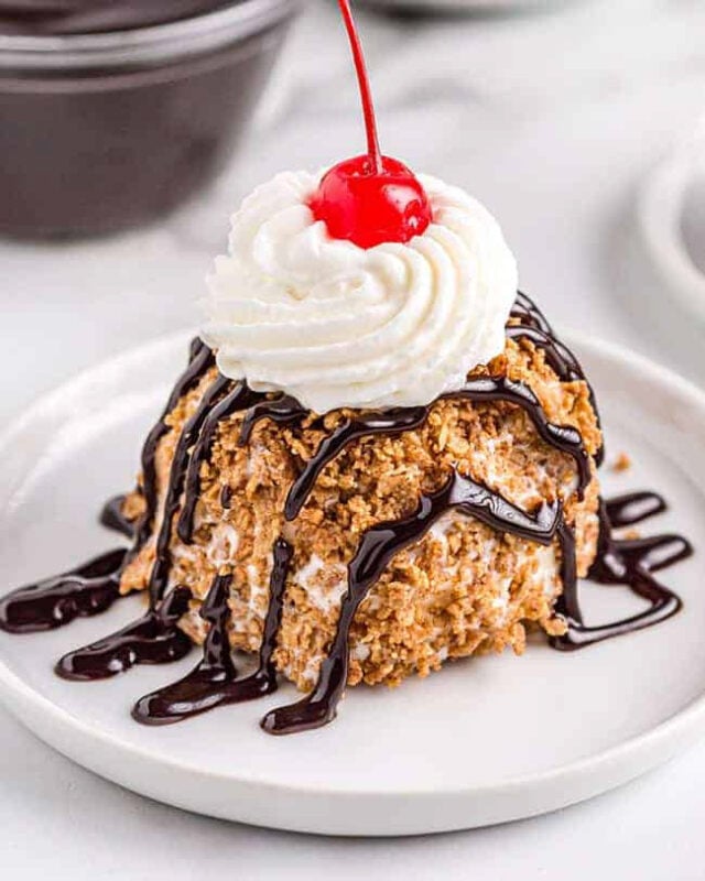fried ice cream with chocolate sauce and a cherry