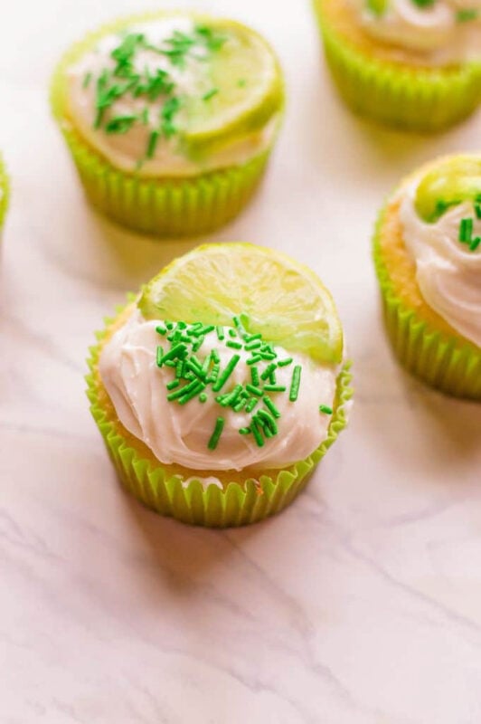 margarita cupcakes with lime wedges on top