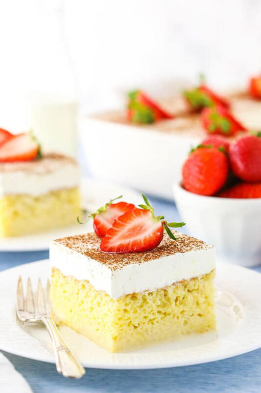 slice of tres leches cake with strawberries on top