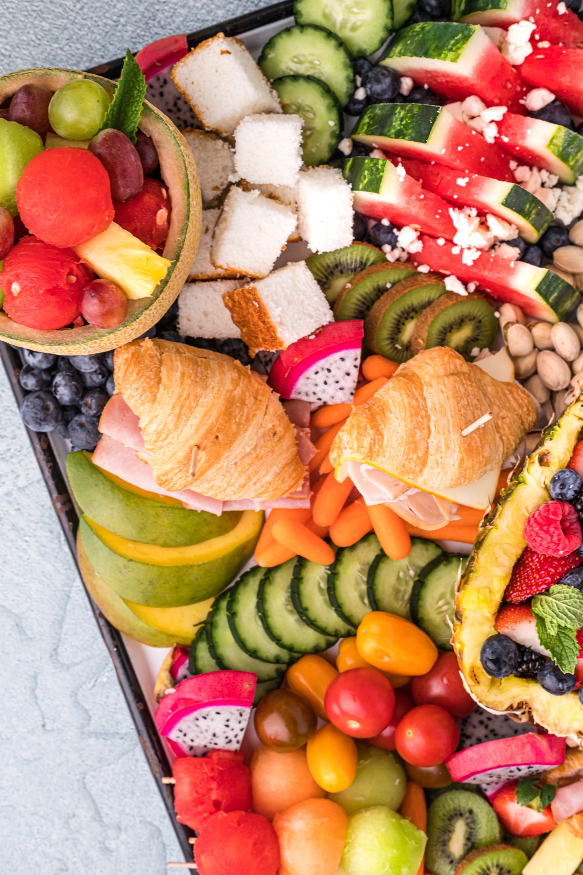 angled summer charcuterie board with fruit