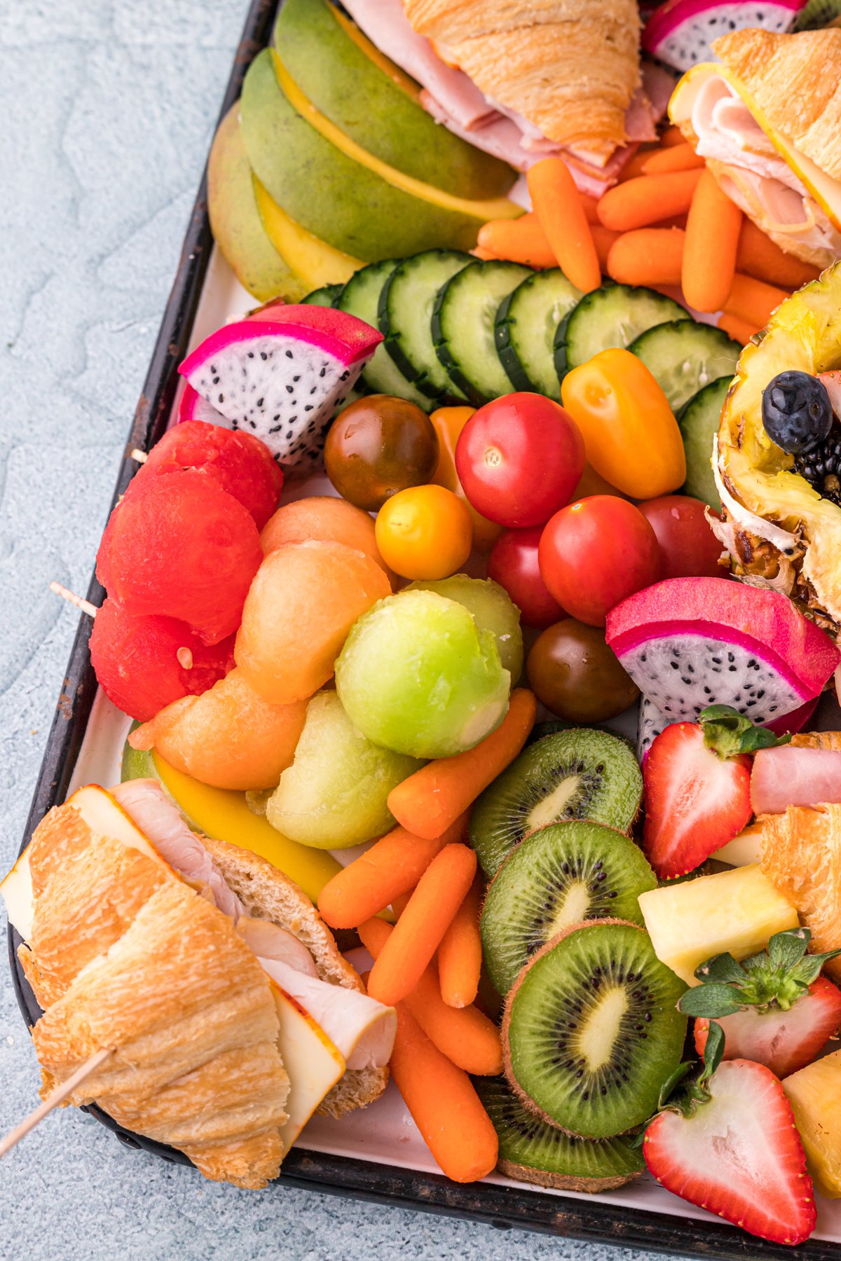 Skewers of fruit on a charcuterie board