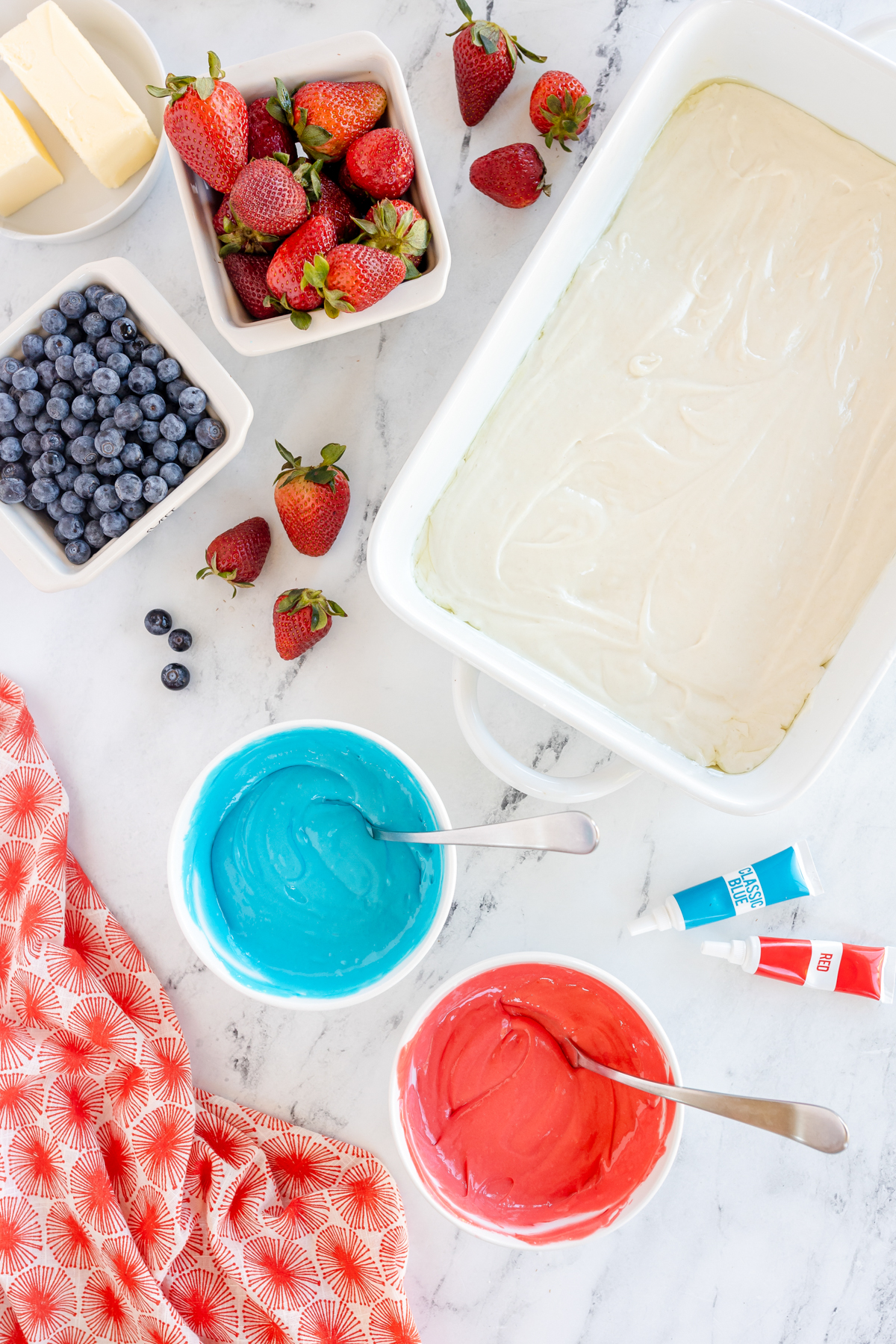 bowls of red and blue cake batter