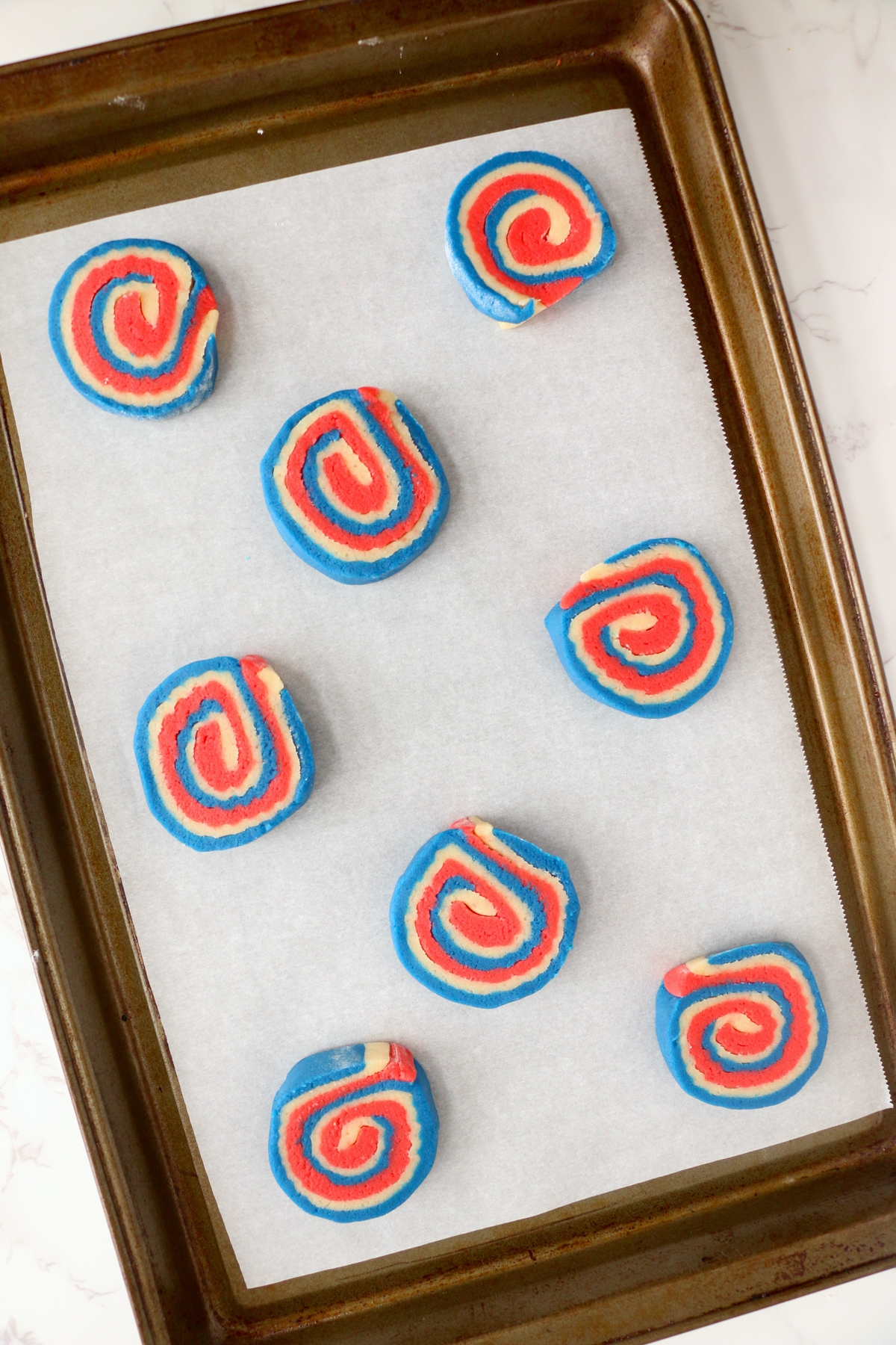4th of July pinwheel cookies on a baking sheet