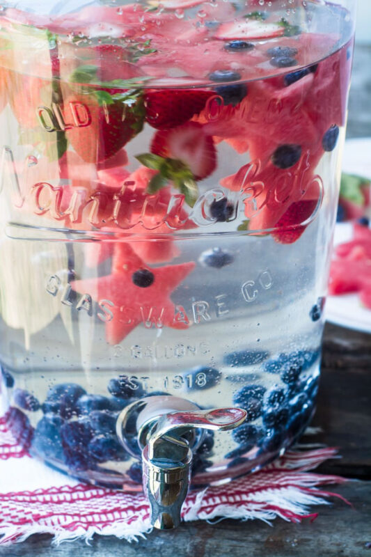 jug with water and fresh berries