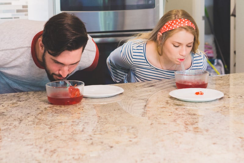 adults with spoons in their mouth