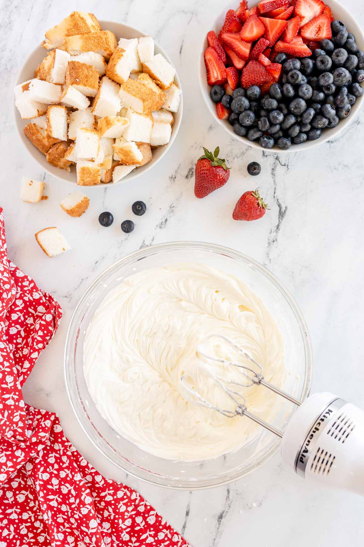 beaters in a bowl of cream cheese mix