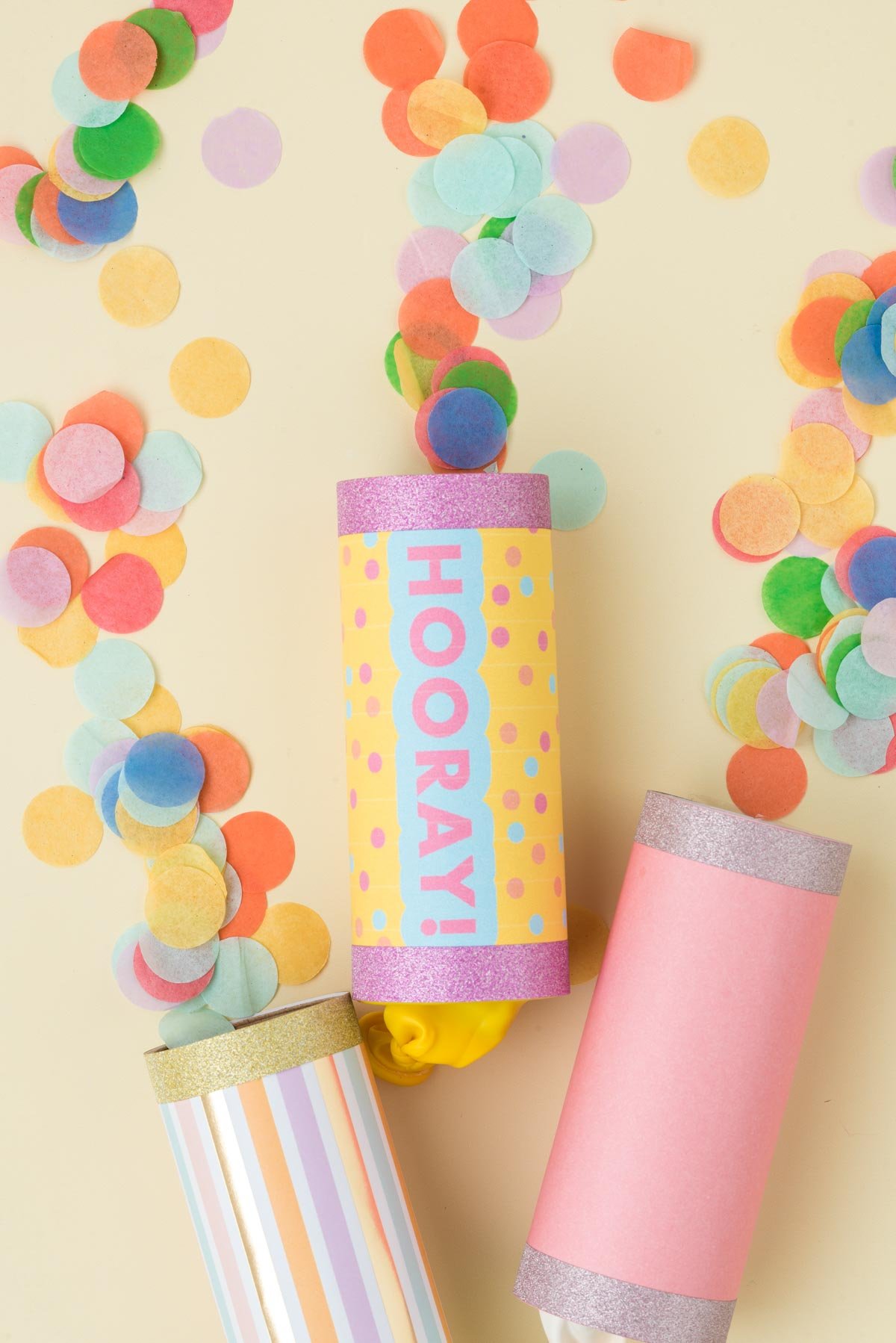 three DIY confetti poppers with confetti