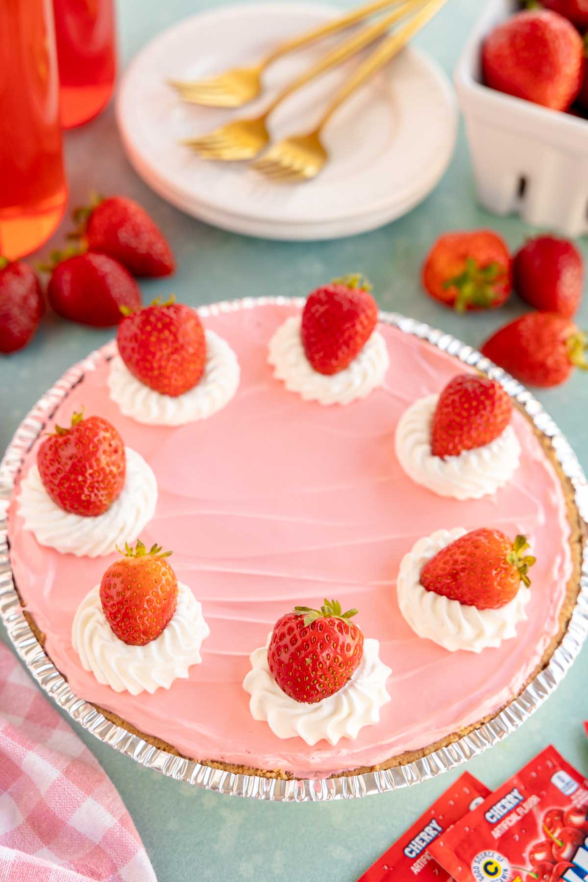 kool aid pie topped with whipped cream and strawberries