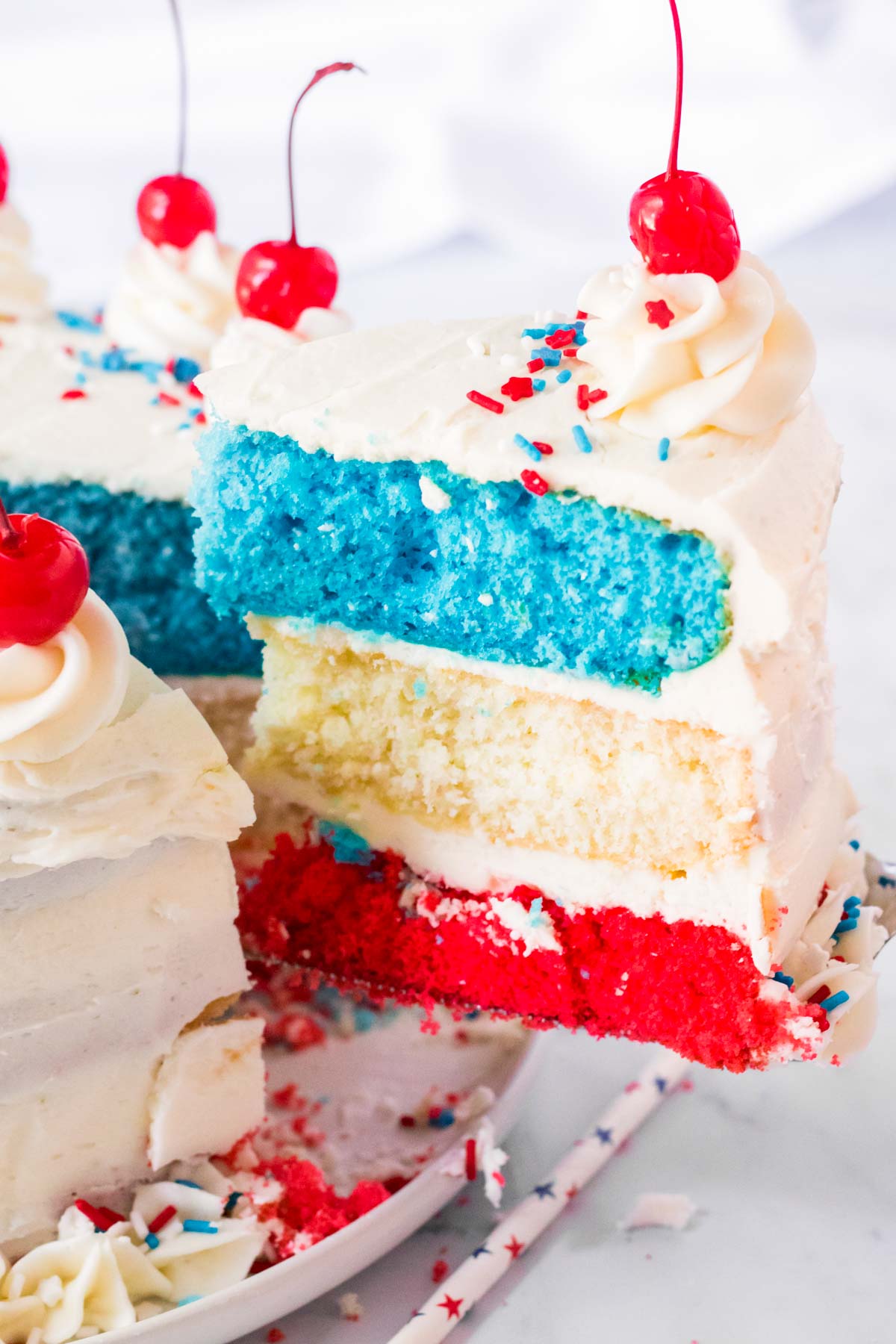 pulling a slice out of a red white and blue cake