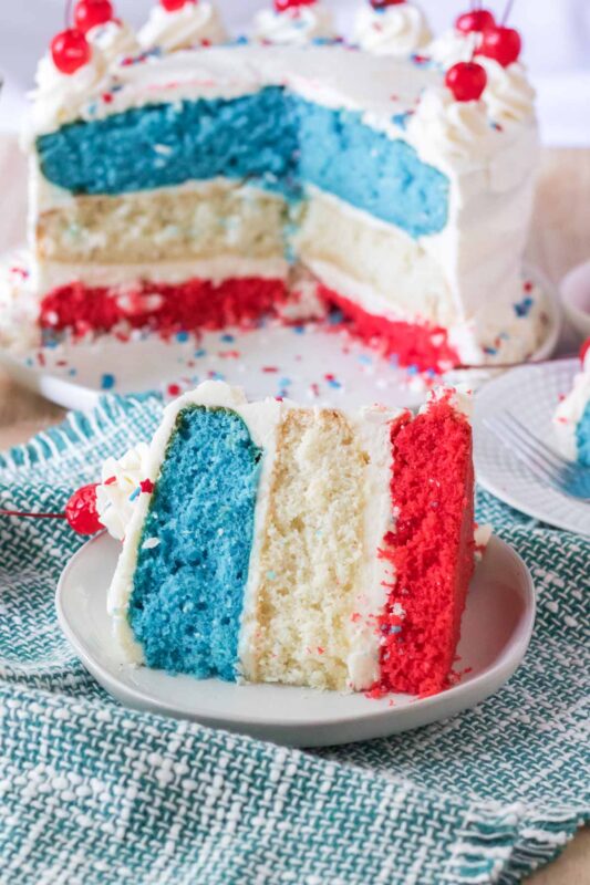 a slice of red white and blue cake on a white plate