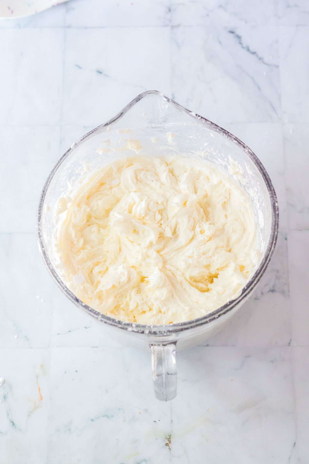 buttercream in a glass mixing bowl