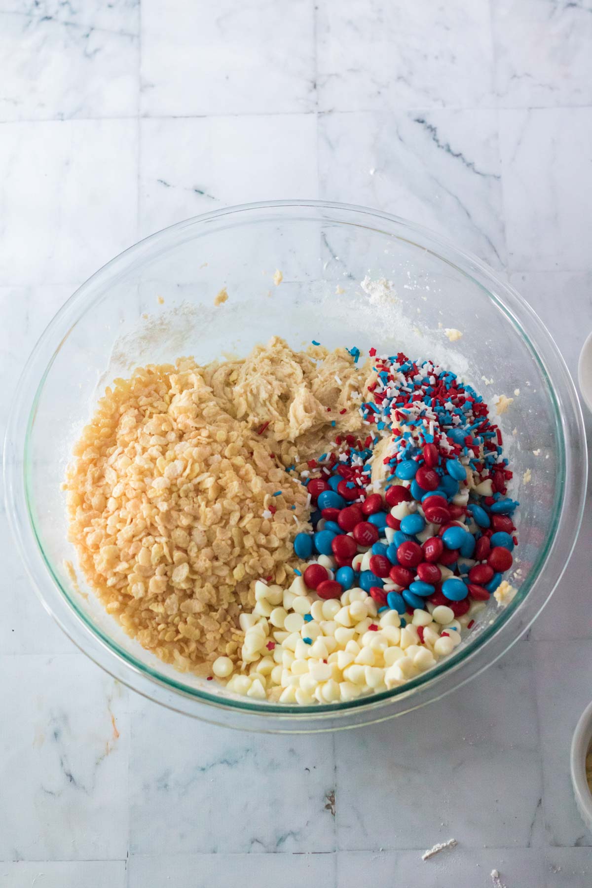 glass bowl with rice krispies, sprinkles, and M&Ms