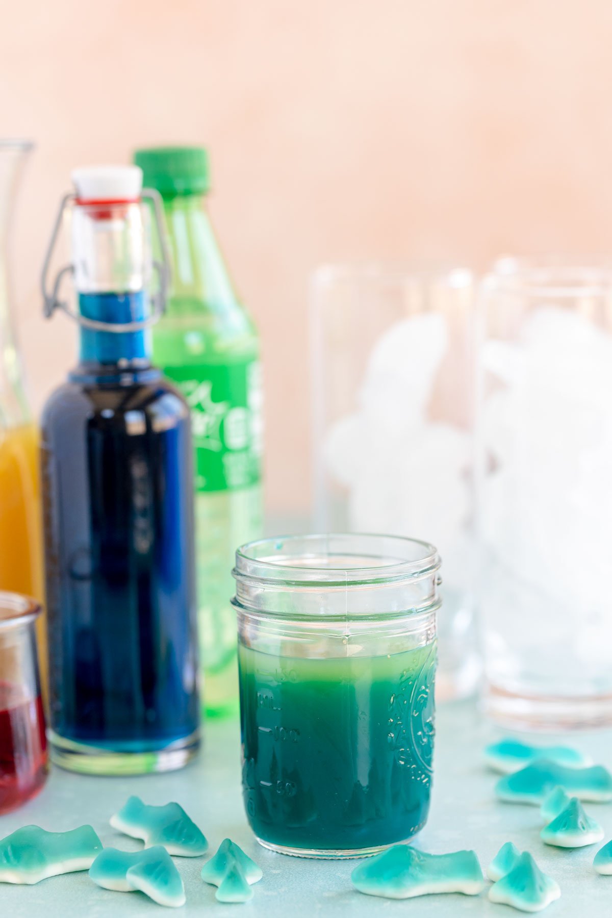 blue curacao syrup and pineapple juice in a glass