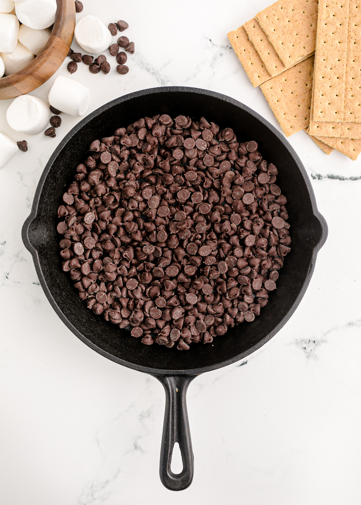 layer of chocolate chips in a cast iron pan