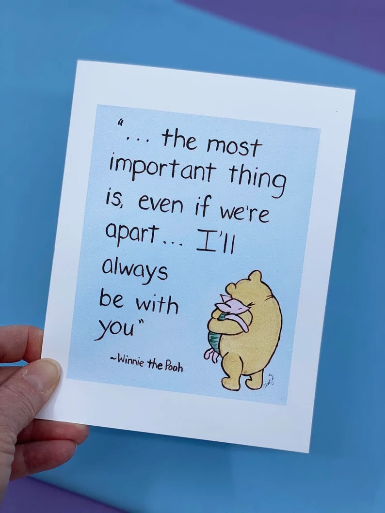 hand holding a card with a winnie the pooh quote