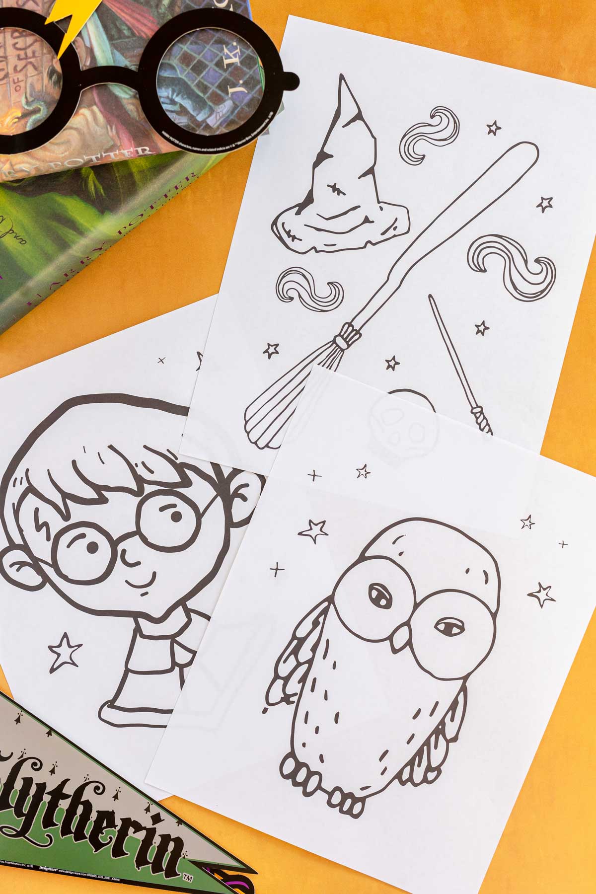 black and white Harry Potter coloring pages in a pile