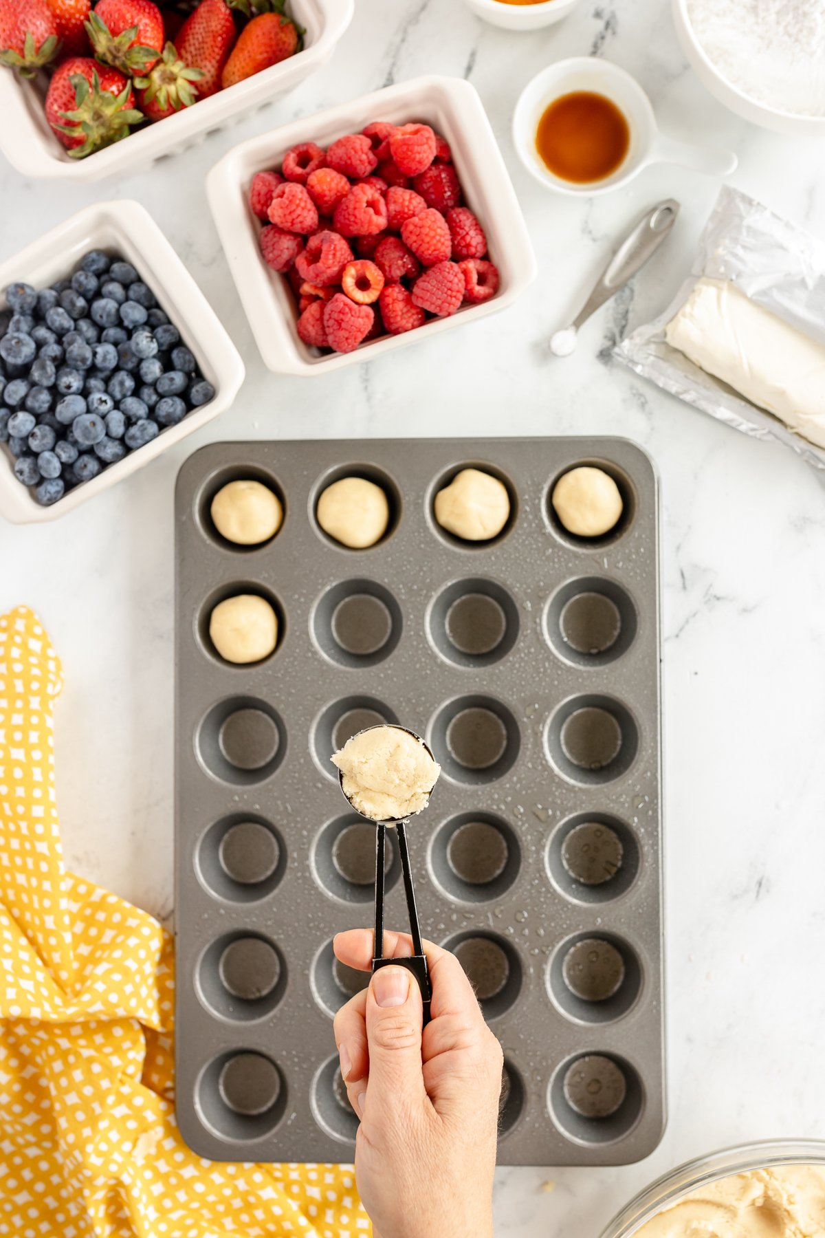 sugar cookie dough balls in mini muffin tins