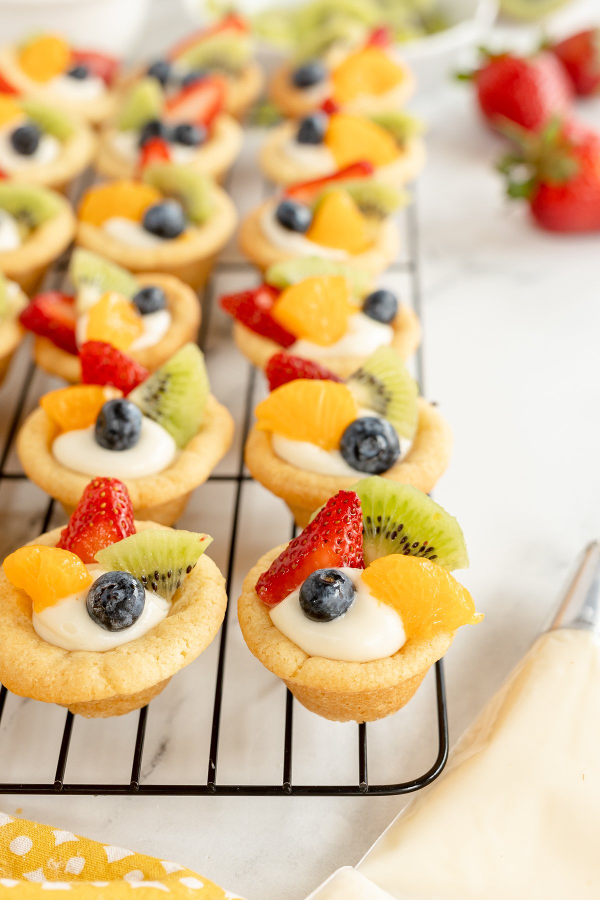 mini fruit tarts on a cooling rack