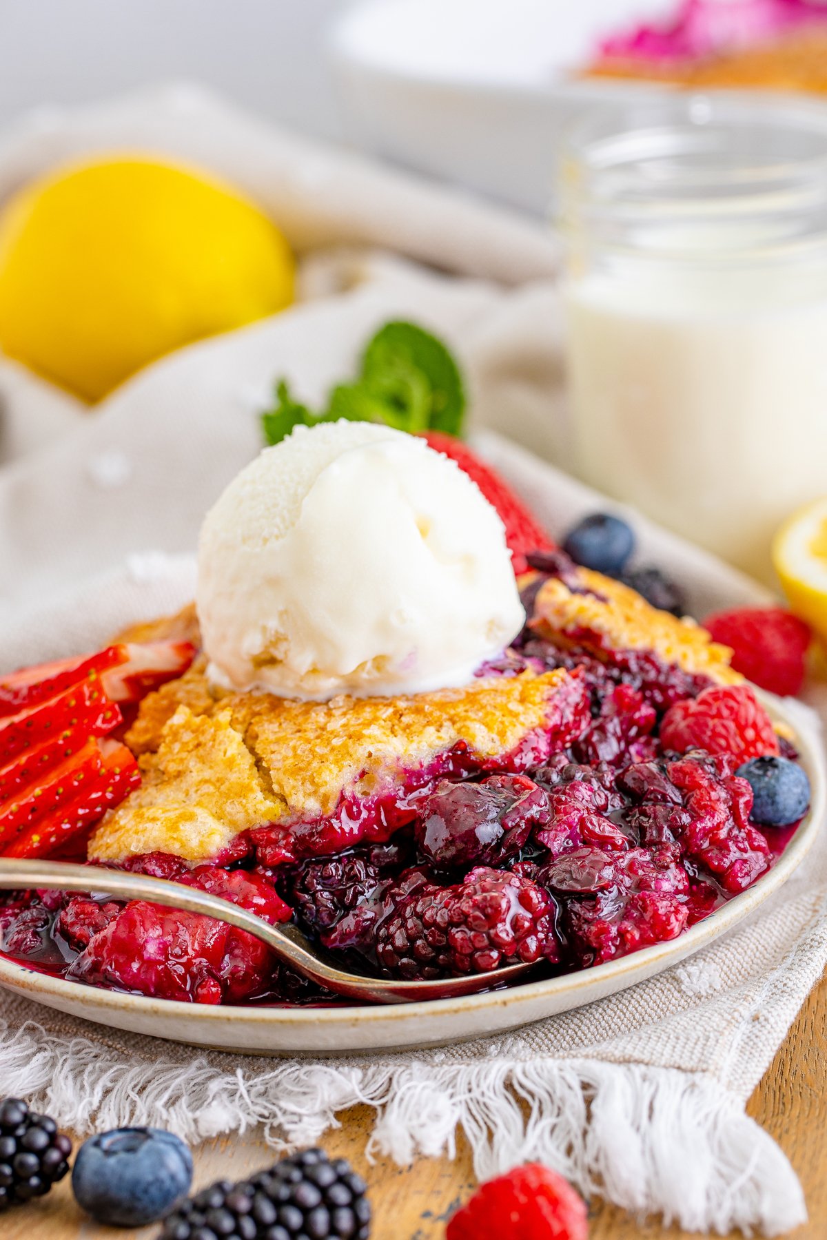 plate full of mixed berry cobbler with ice cream