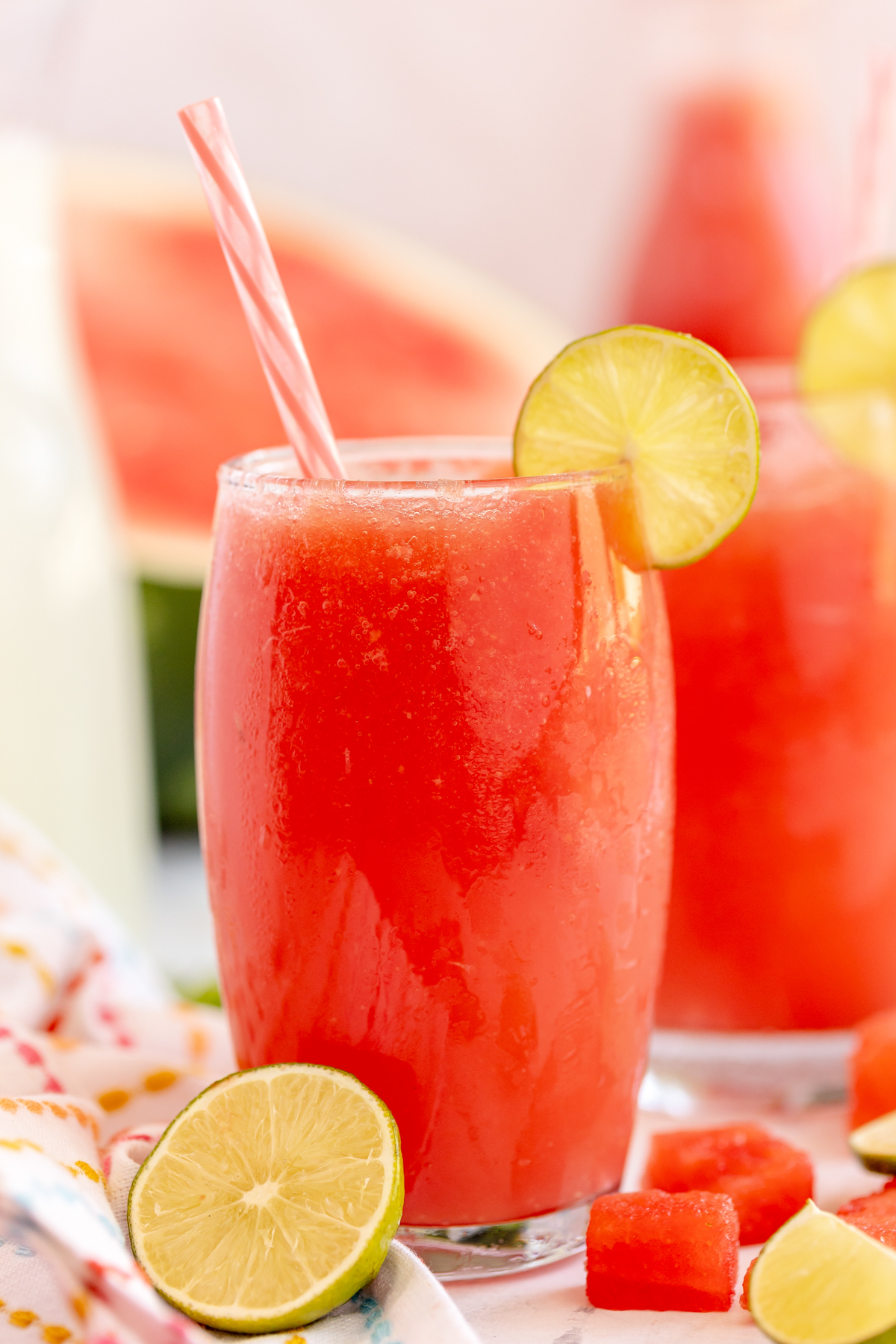 watermelon slushie garnished with a lime wedge