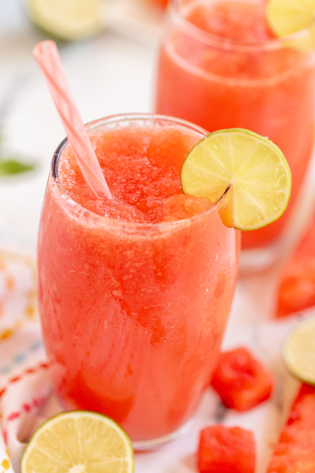 watermelon slushie garnished with a lime wedge
