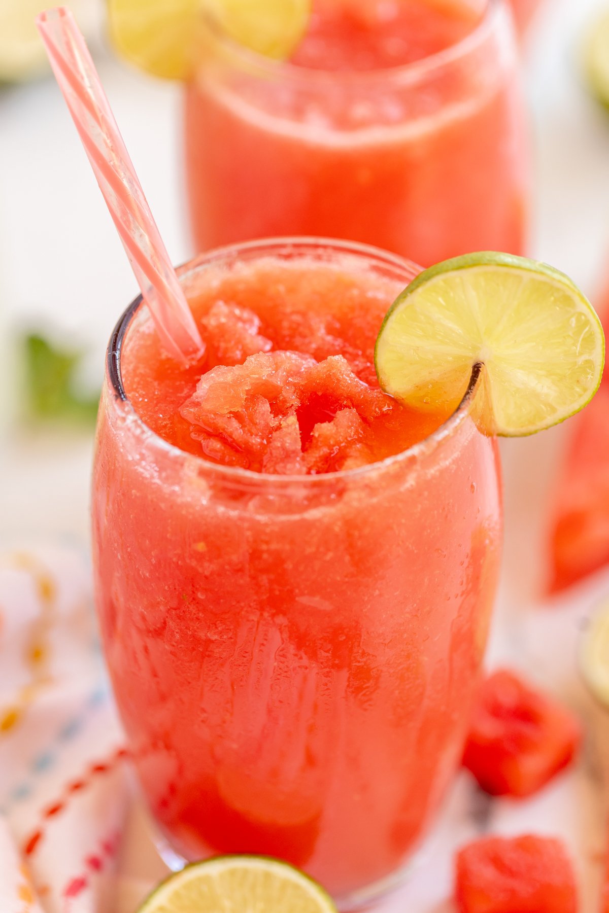 Watermelon slushie with a lime wedge garnish