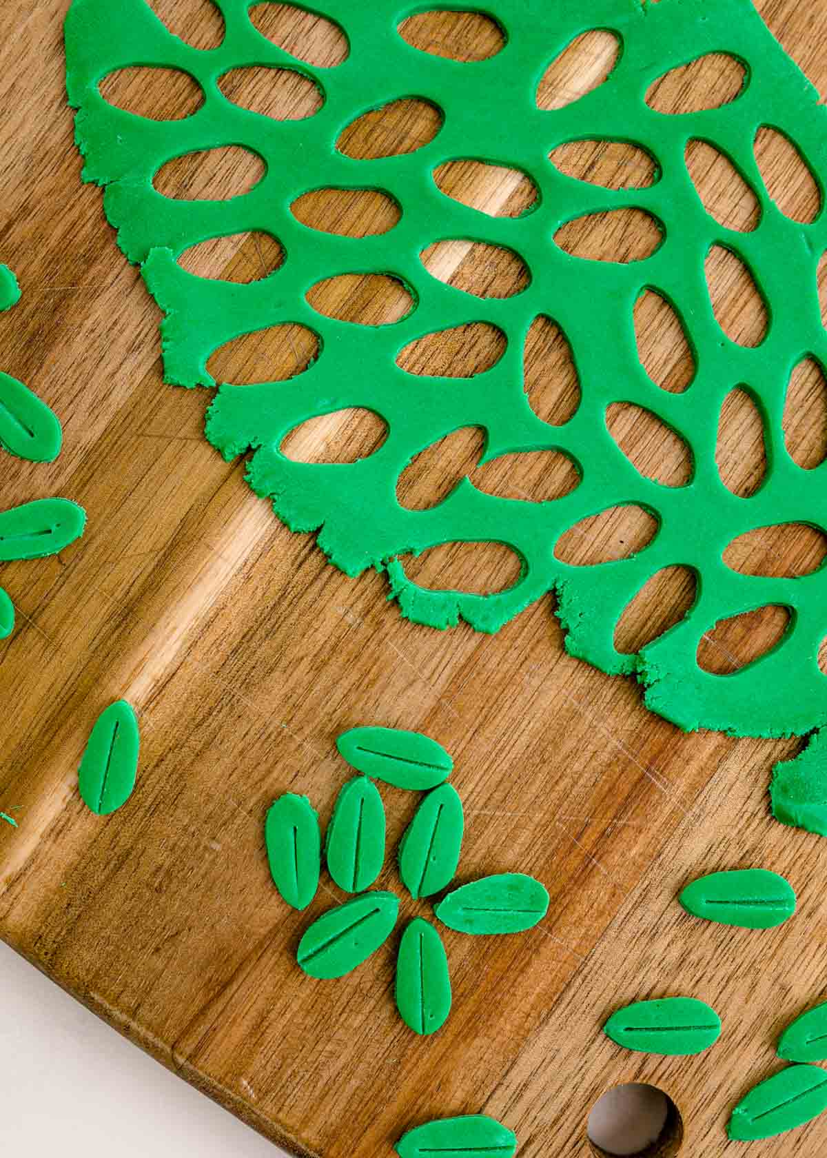 green fondant cut into tiny leaves