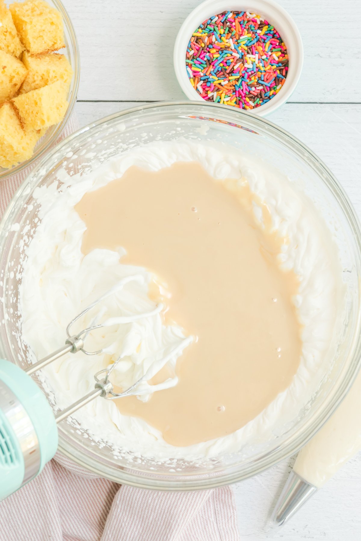 whipped cream and condensed milk in a bowl