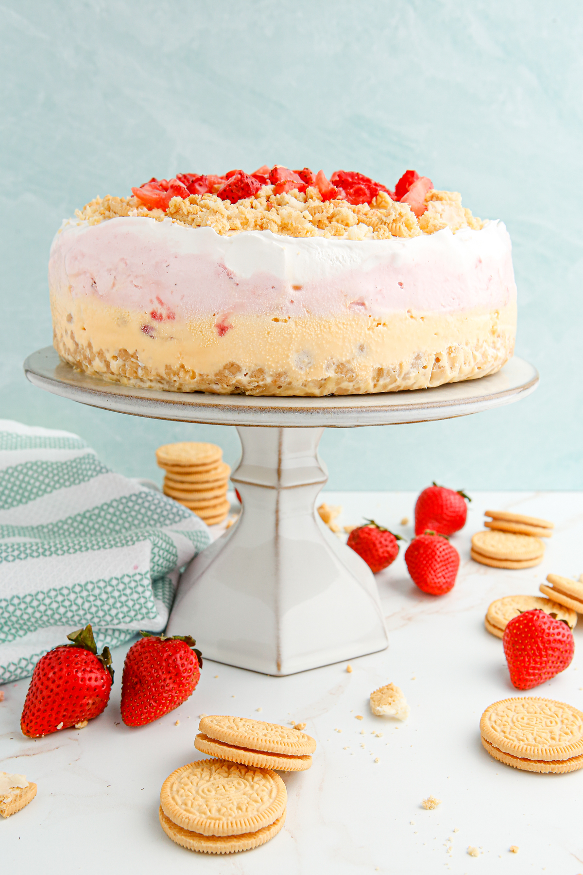 strawberry ice cream cake on a cake stand