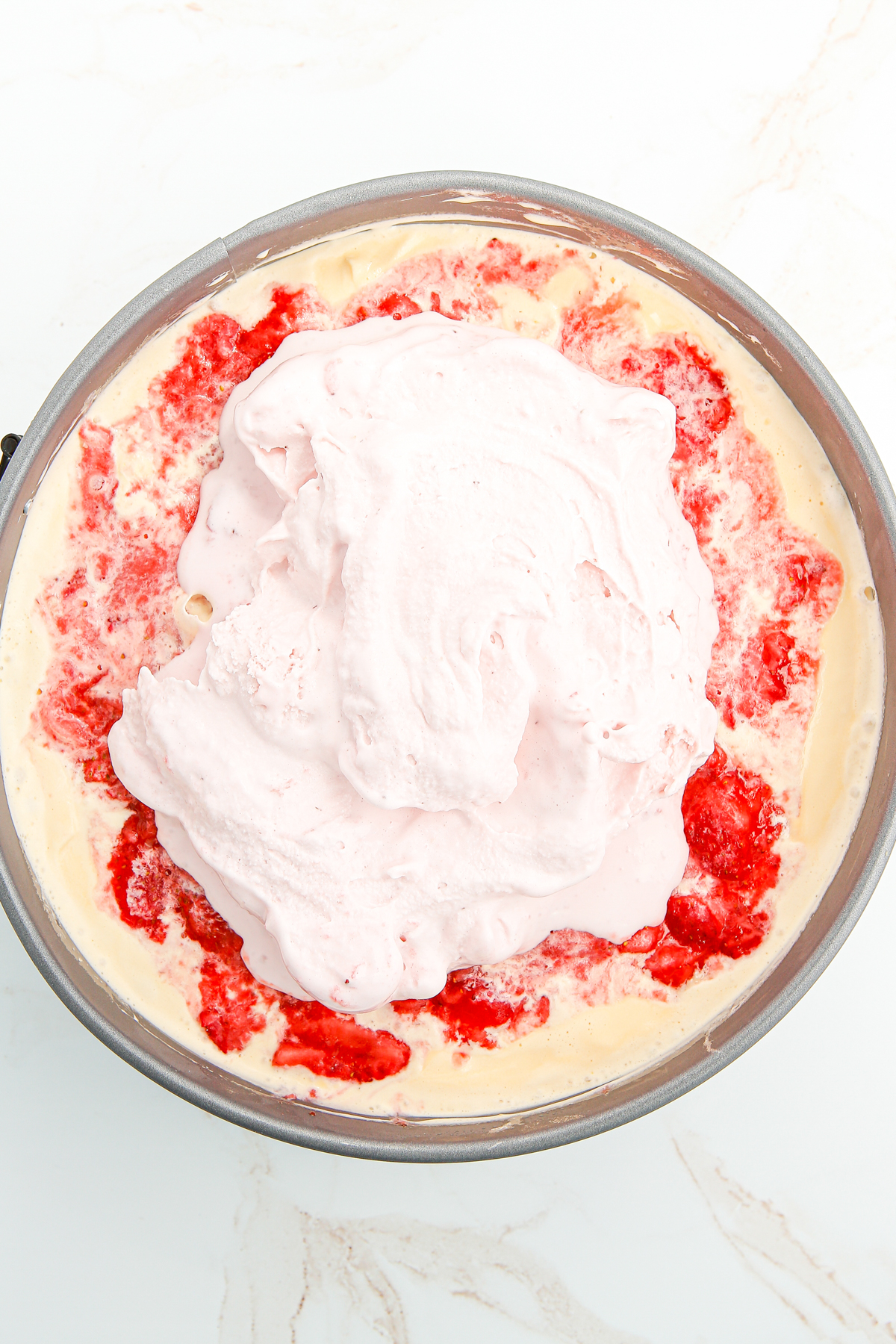 strawberry ice cream on top of mashed strawberries