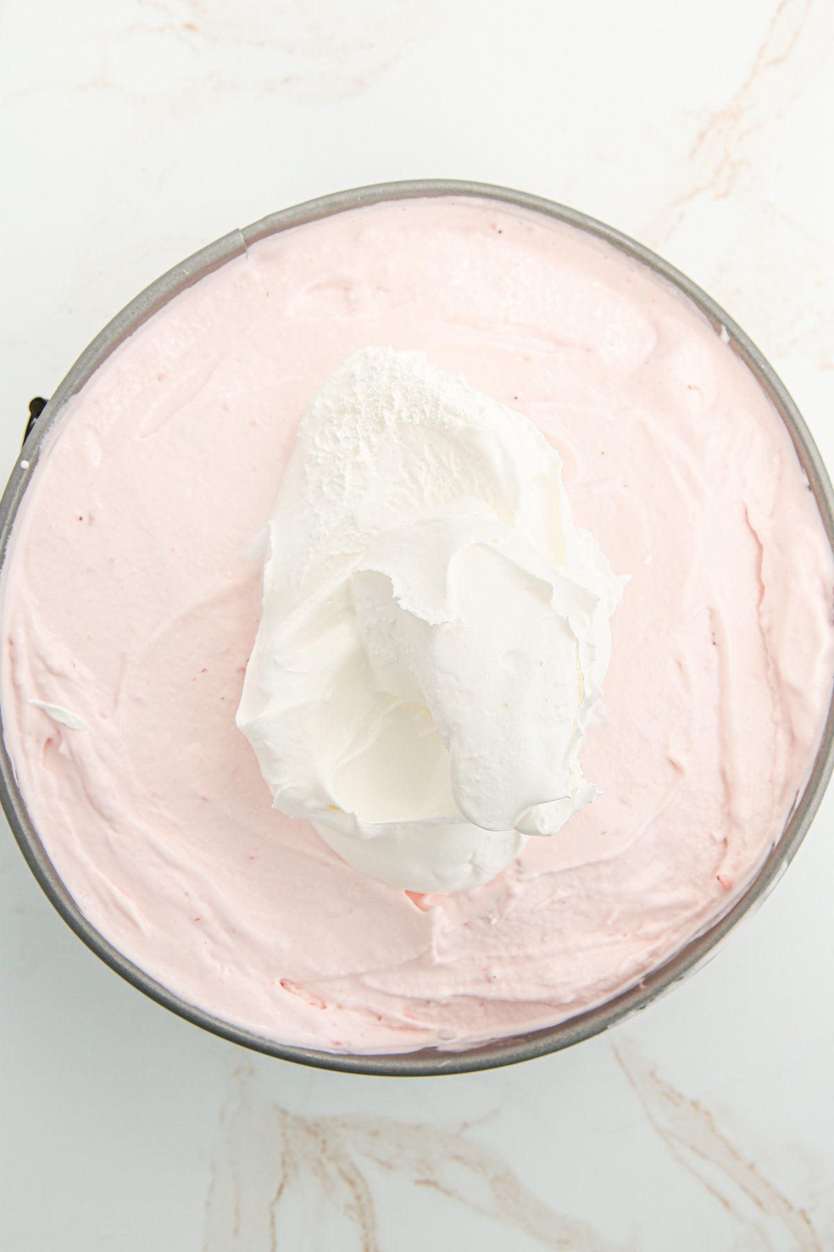 whipped cream on top of strawberry ice cream