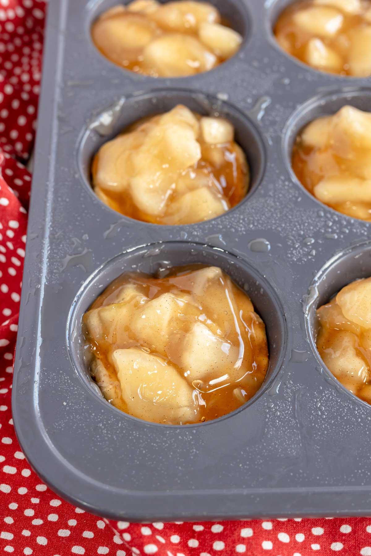 apple pie filling in a muffin tin