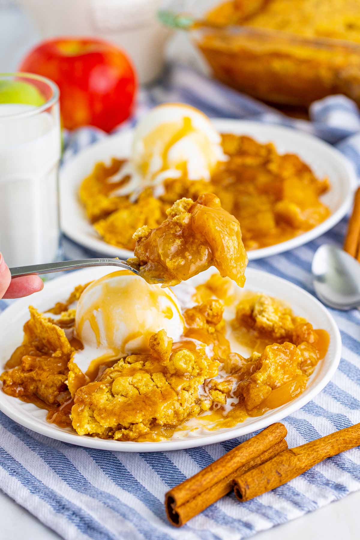 white plates with caramel apple dump cake